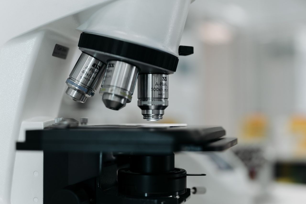about-us-02 Detailed image of a microscope lens, highlighting precision in scientific research.
